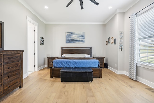 bedroom with ornamental molding, light hardwood / wood-style floors, and ceiling fan