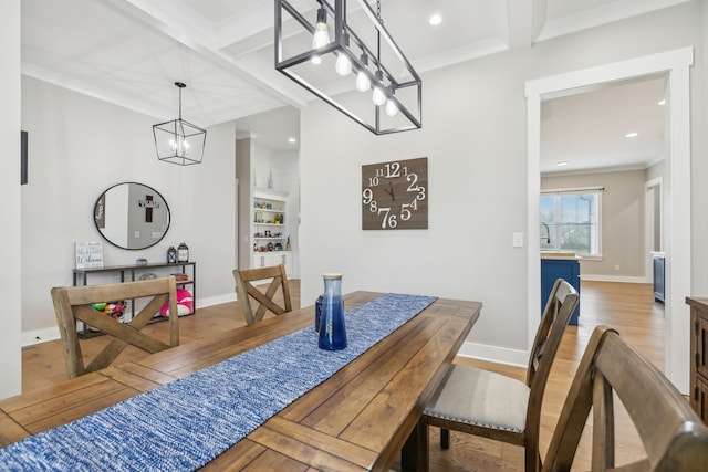 dining area with ornamental molding, beamed ceiling, and hardwood / wood-style flooring