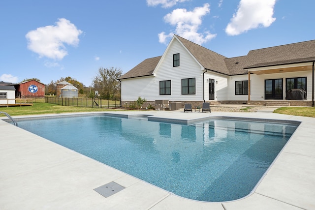 view of swimming pool with a lawn and a patio area