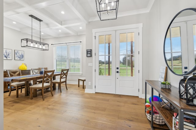 foyer with plenty of natural light, light wood-type flooring, and french doors