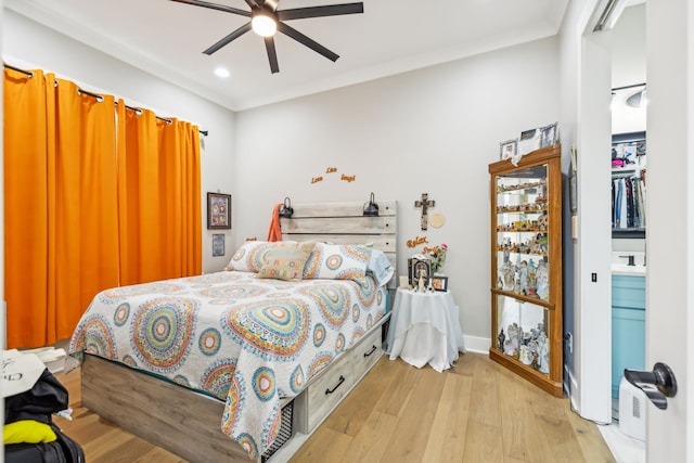 bedroom with ornamental molding, light hardwood / wood-style flooring, and ceiling fan