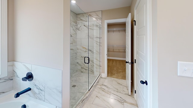 bathroom featuring a shower with shower door