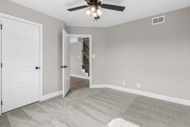 unfurnished bedroom featuring ceiling fan and carpet