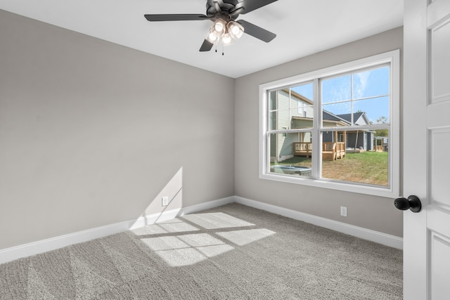 carpeted spare room with ceiling fan