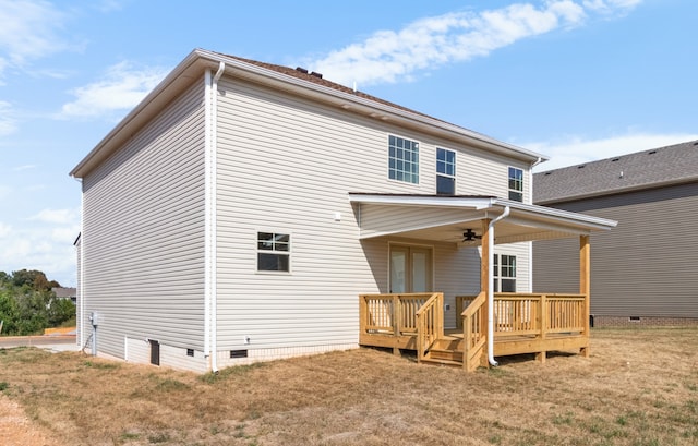 back of property with a lawn and ceiling fan