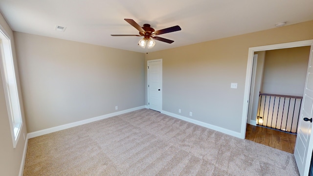 unfurnished bedroom featuring ceiling fan and light carpet