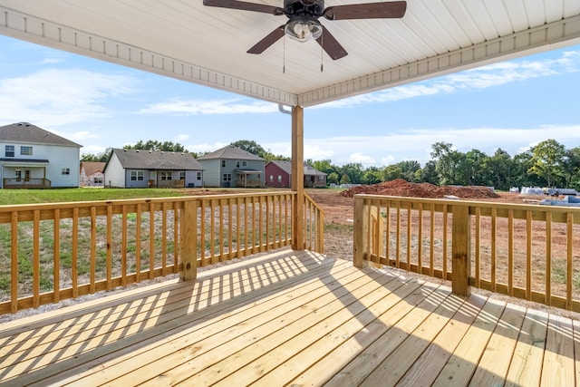 wooden terrace featuring a yard and ceiling fan