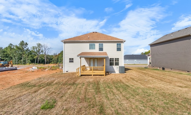 rear view of house with a deck, cooling unit, and a yard