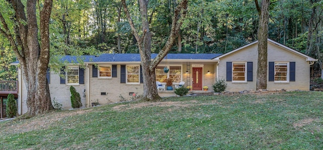 ranch-style house with covered porch and a front yard