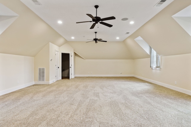 additional living space featuring light carpet, ceiling fan, and vaulted ceiling