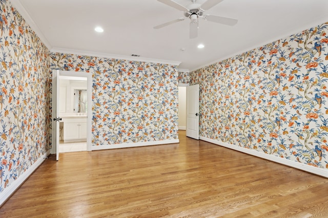 unfurnished room featuring ceiling fan, ornamental molding, and light wood-type flooring