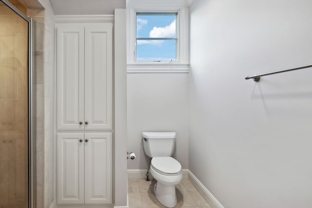 bathroom featuring tile patterned floors, an enclosed shower, and toilet