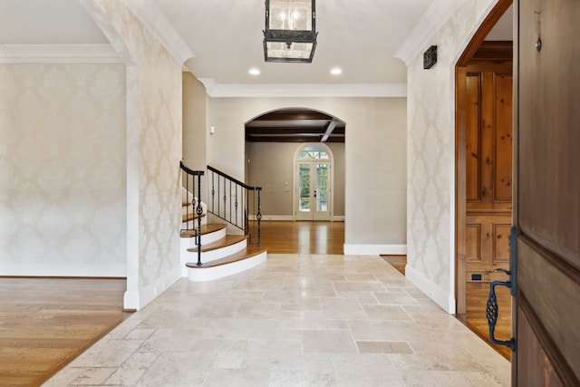 entrance foyer featuring ornamental molding, light hardwood / wood-style flooring, and french doors