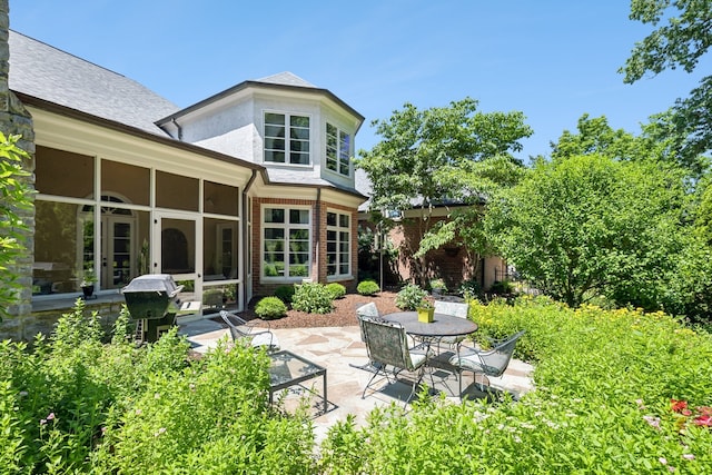 back of house with a patio