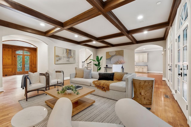 living room featuring beam ceiling, french doors, and coffered ceiling