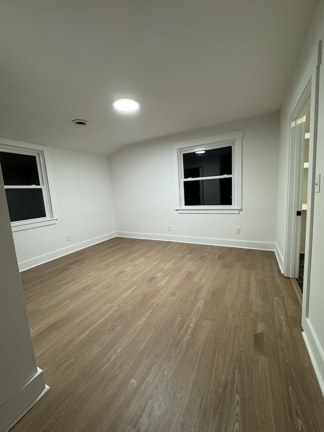 unfurnished room with wood-type flooring