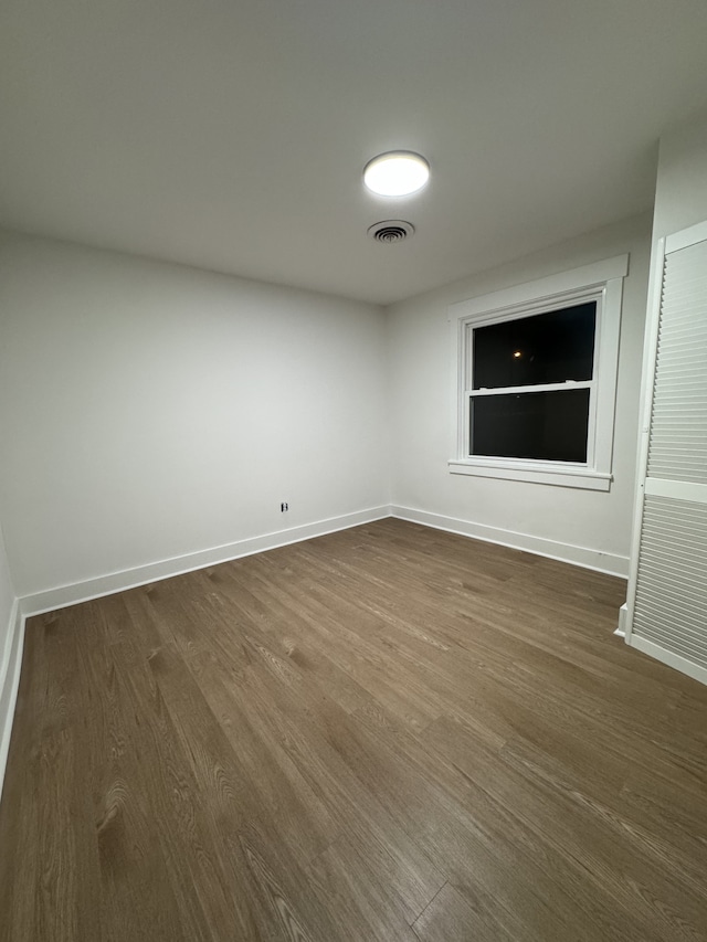 empty room with dark hardwood / wood-style floors