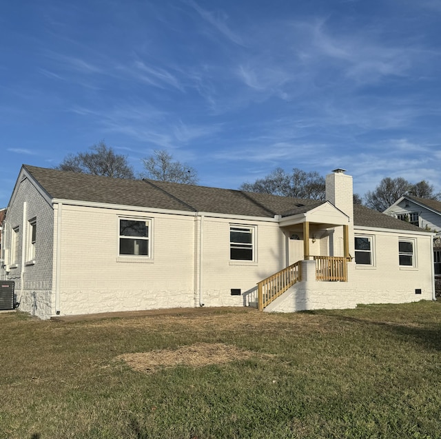 exterior space featuring cooling unit and a yard