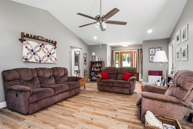 living room featuring lofted ceiling, ceiling fan, and light hardwood / wood-style flooring