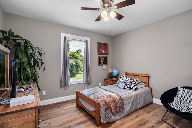 bedroom with light hardwood / wood-style floors and ceiling fan