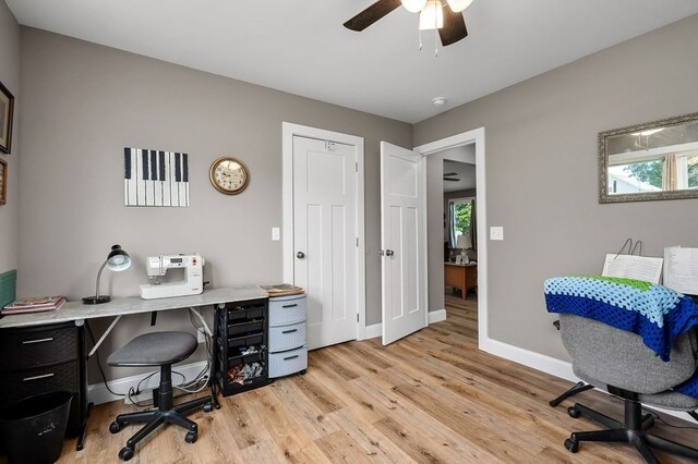 office with light hardwood / wood-style floors and ceiling fan