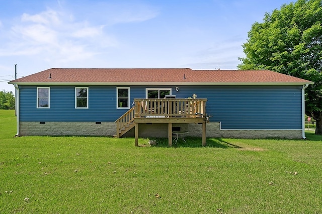 rear view of property with a wooden deck and a lawn