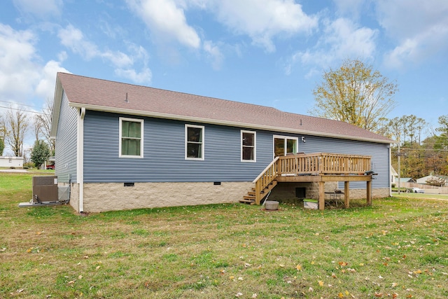 back of property featuring central air condition unit, a yard, and a deck