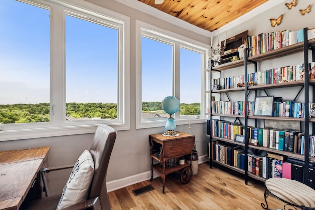 office featuring light hardwood / wood-style flooring, crown molding, and wood ceiling