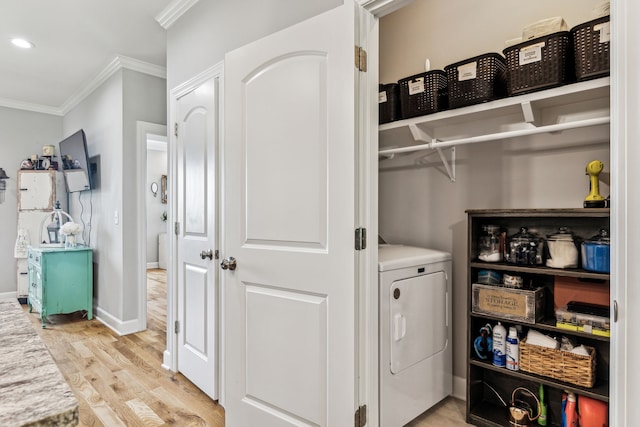 laundry room featuring light wood-type flooring, crown molding, and washer / dryer