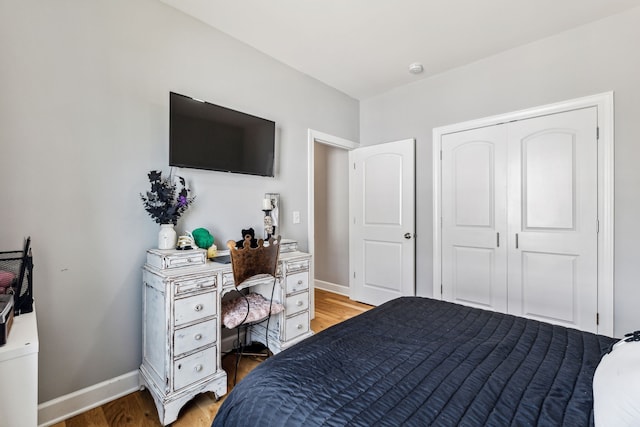 bedroom with hardwood / wood-style floors and a closet