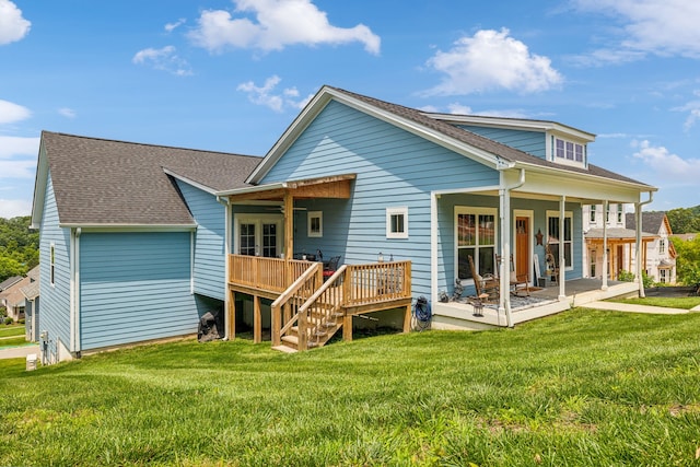 rear view of property featuring a lawn