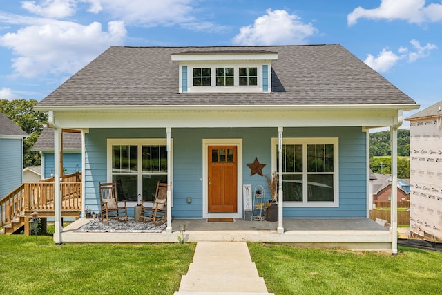 view of front of property with a front yard and covered porch