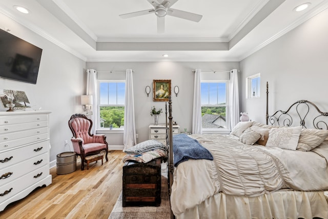 bedroom with ceiling fan, multiple windows, light wood-type flooring, and crown molding