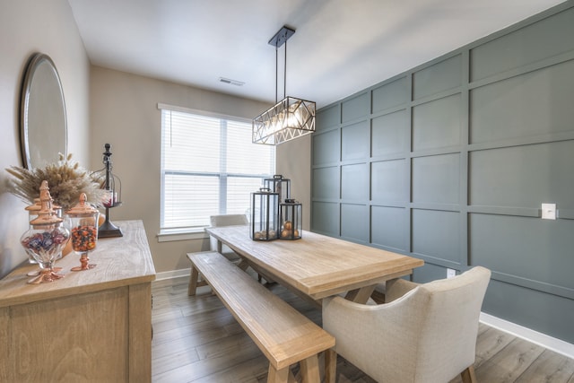 dining room featuring dark wood-type flooring and an inviting chandelier