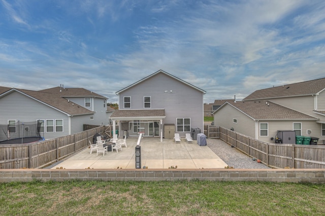 rear view of house with a yard and a patio area