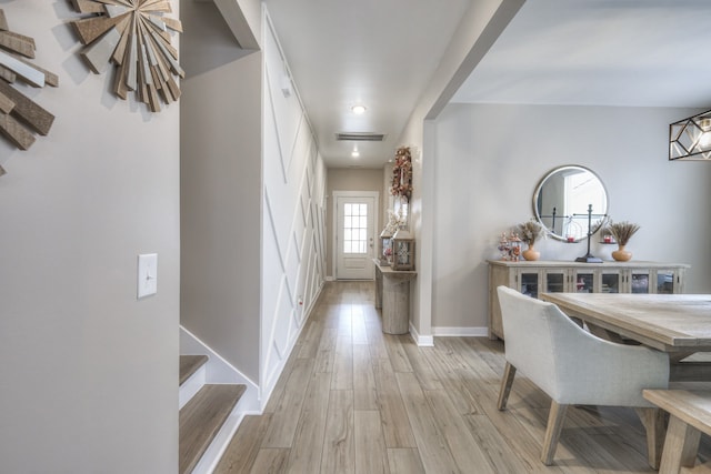 corridor with light hardwood / wood-style flooring