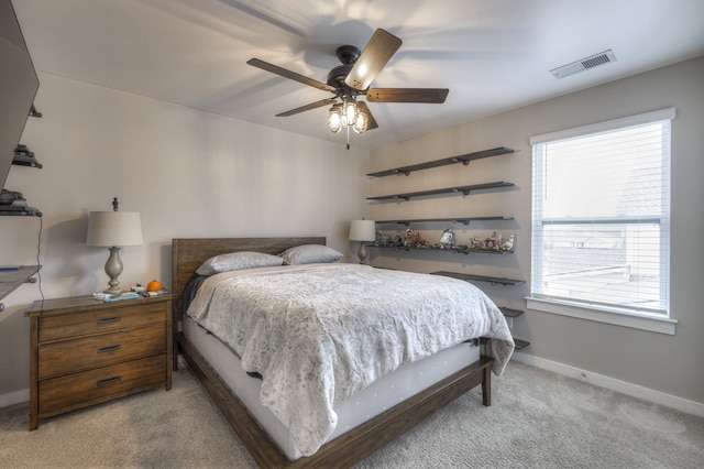 bedroom featuring light colored carpet, multiple windows, and ceiling fan