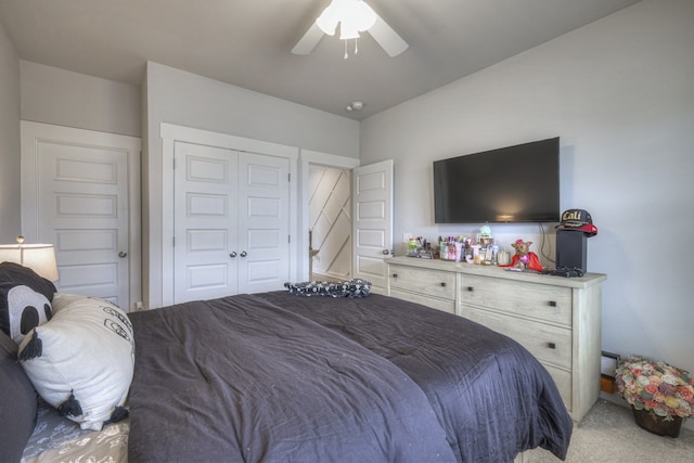 carpeted bedroom with ceiling fan and a closet