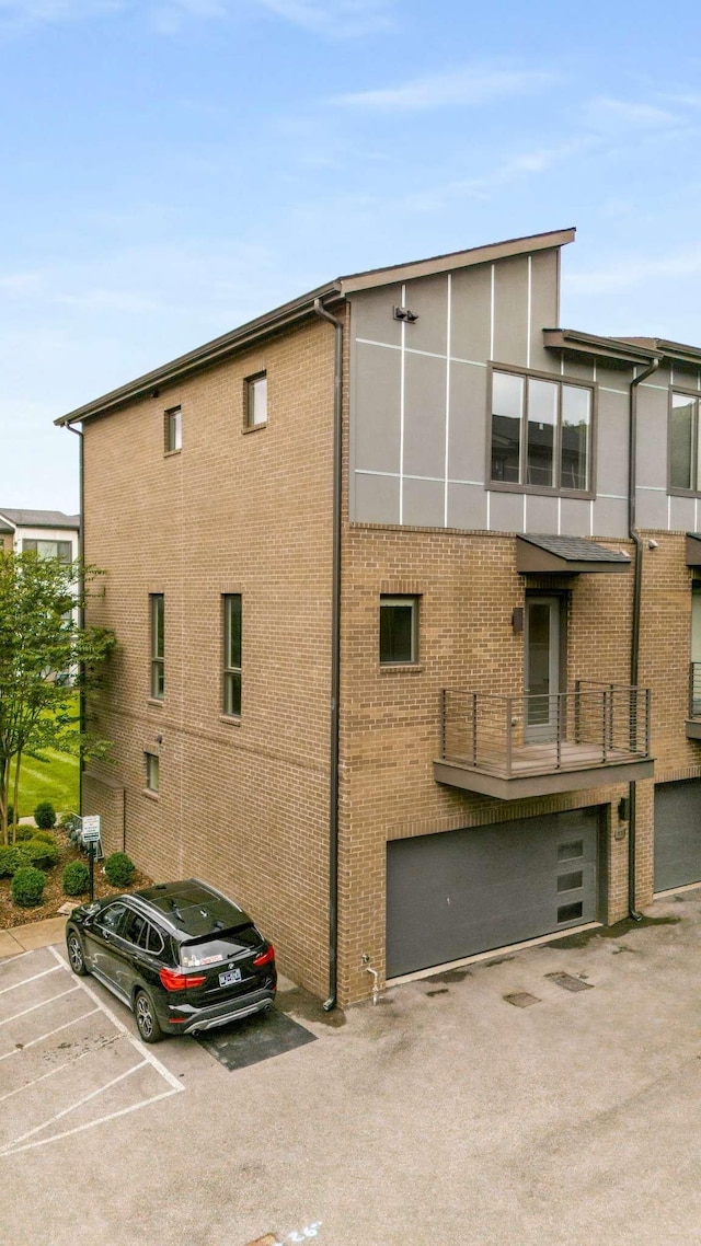 view of property featuring uncovered parking and a garage