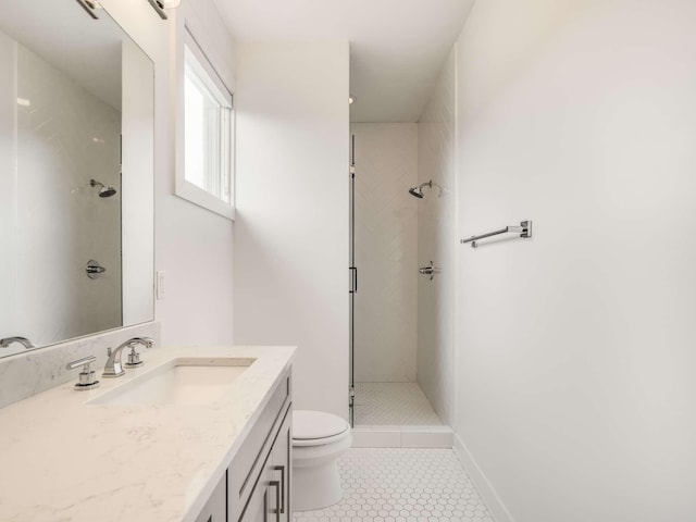 bathroom featuring a stall shower, toilet, tile patterned flooring, and vanity