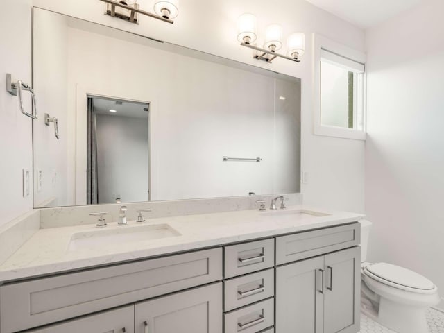 full bathroom featuring toilet, double vanity, and tile patterned floors
