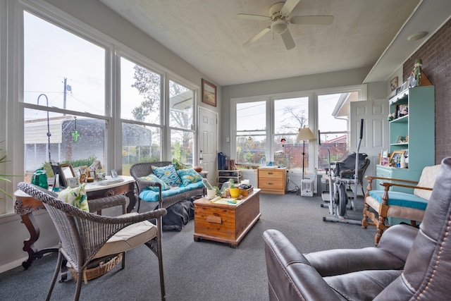 sunroom / solarium with a healthy amount of sunlight and ceiling fan