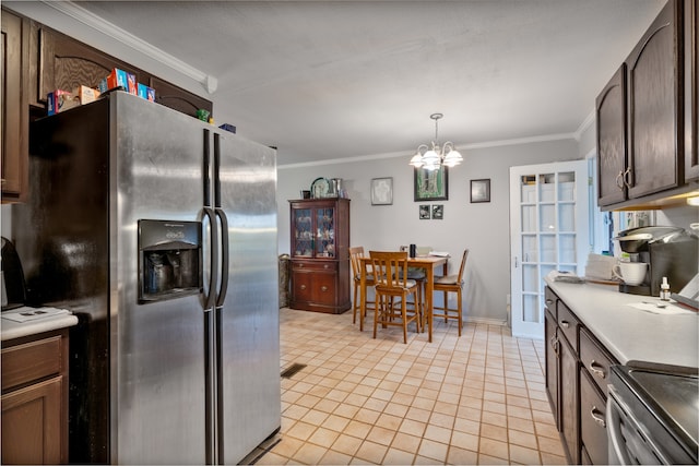 kitchen with stainless steel appliances, decorative light fixtures, crown molding, and a notable chandelier