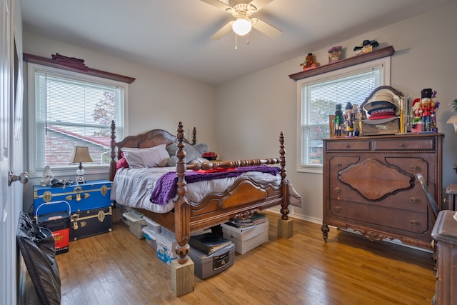 bedroom with light hardwood / wood-style flooring and ceiling fan