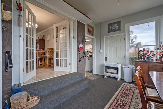 interior space featuring light colored carpet, heating unit, french doors, and crown molding