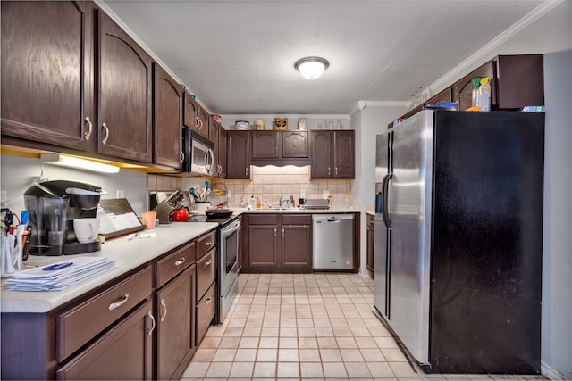 kitchen with stainless steel appliances, light tile patterned flooring, ornamental molding, dark brown cabinets, and decorative backsplash