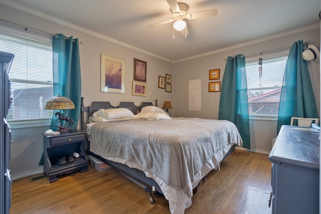 bedroom with hardwood / wood-style flooring, ceiling fan, and crown molding