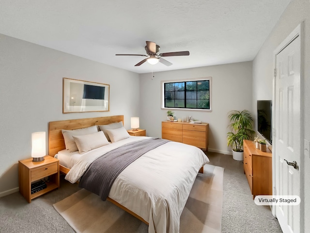 bedroom with ceiling fan and light carpet