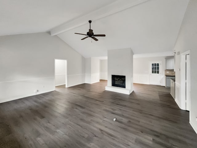 unfurnished living room with beam ceiling, dark hardwood / wood-style flooring, high vaulted ceiling, a large fireplace, and ceiling fan