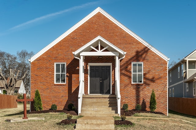 bungalow-style home with a front lawn